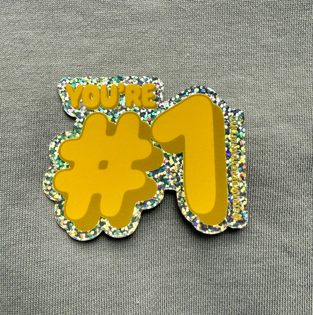 Colorful "YOU’RE #1" sticker by Strawberry Bandit with bold lettering on a white background.