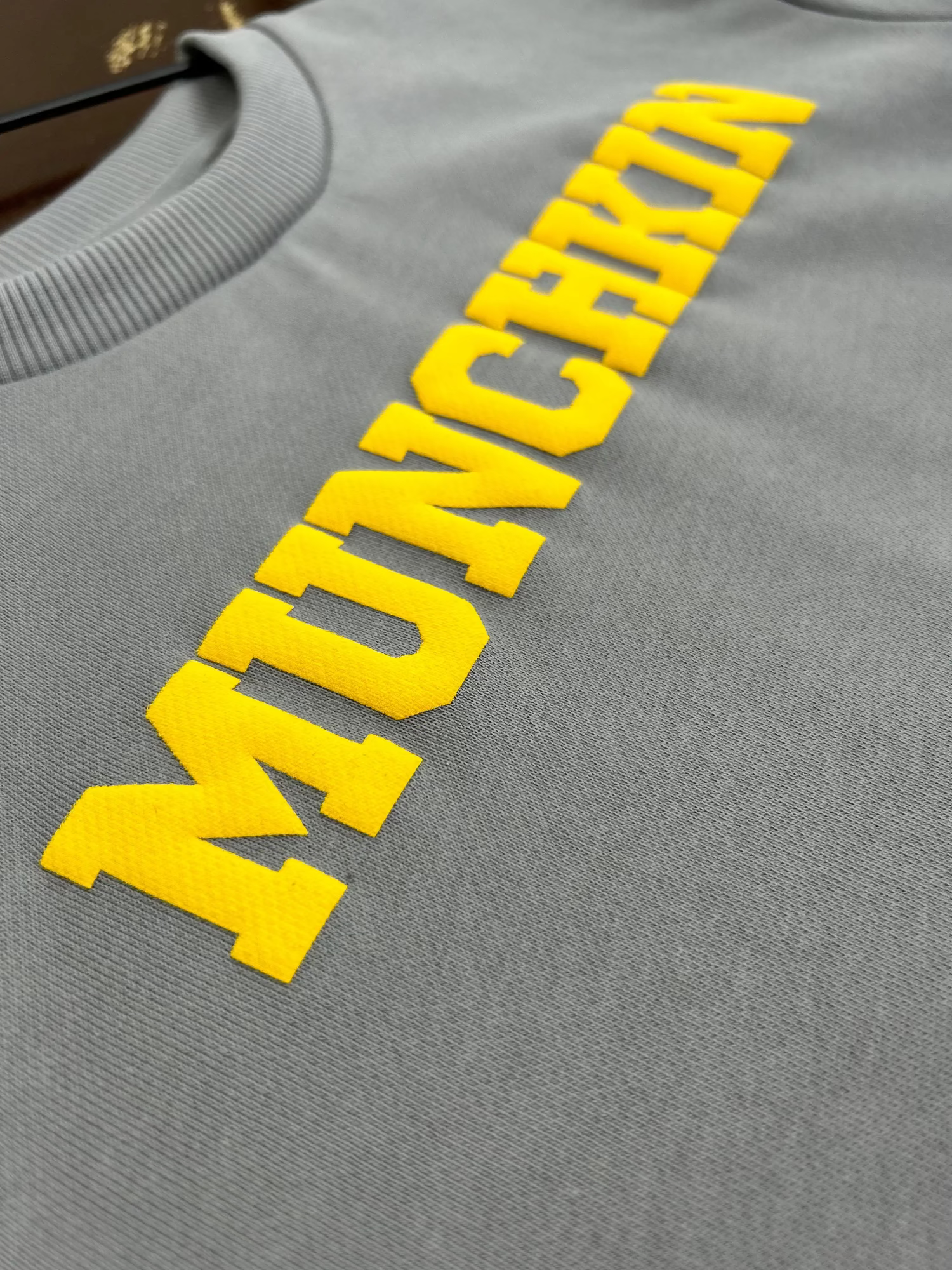 ‘MUNCHKIN’ Crewneck with Yellow Puff Print Strawberry Bandit, grey Cotton close-up.