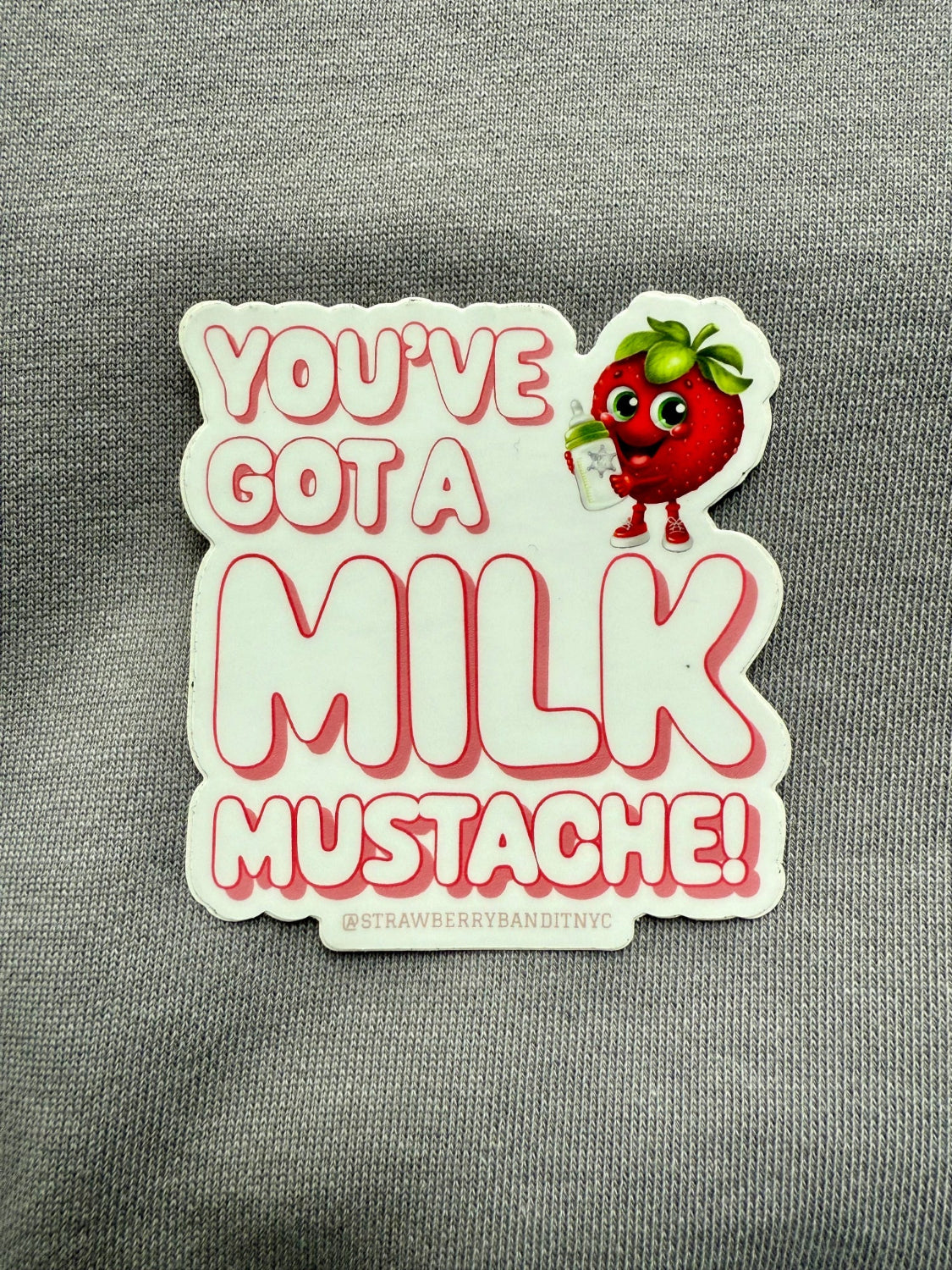 Strawberry Bandit You’ve Got a Milk Mustache sticker with playful milk mustache graphic on glossy paper.